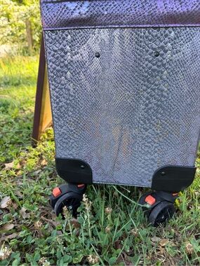 Bootique Purple Snakeskin Travel Bag with Black Wheels and Orange Accents